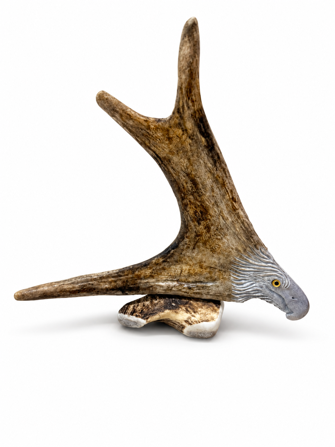 Hand-carved moose antler eagle sculpture on white background
