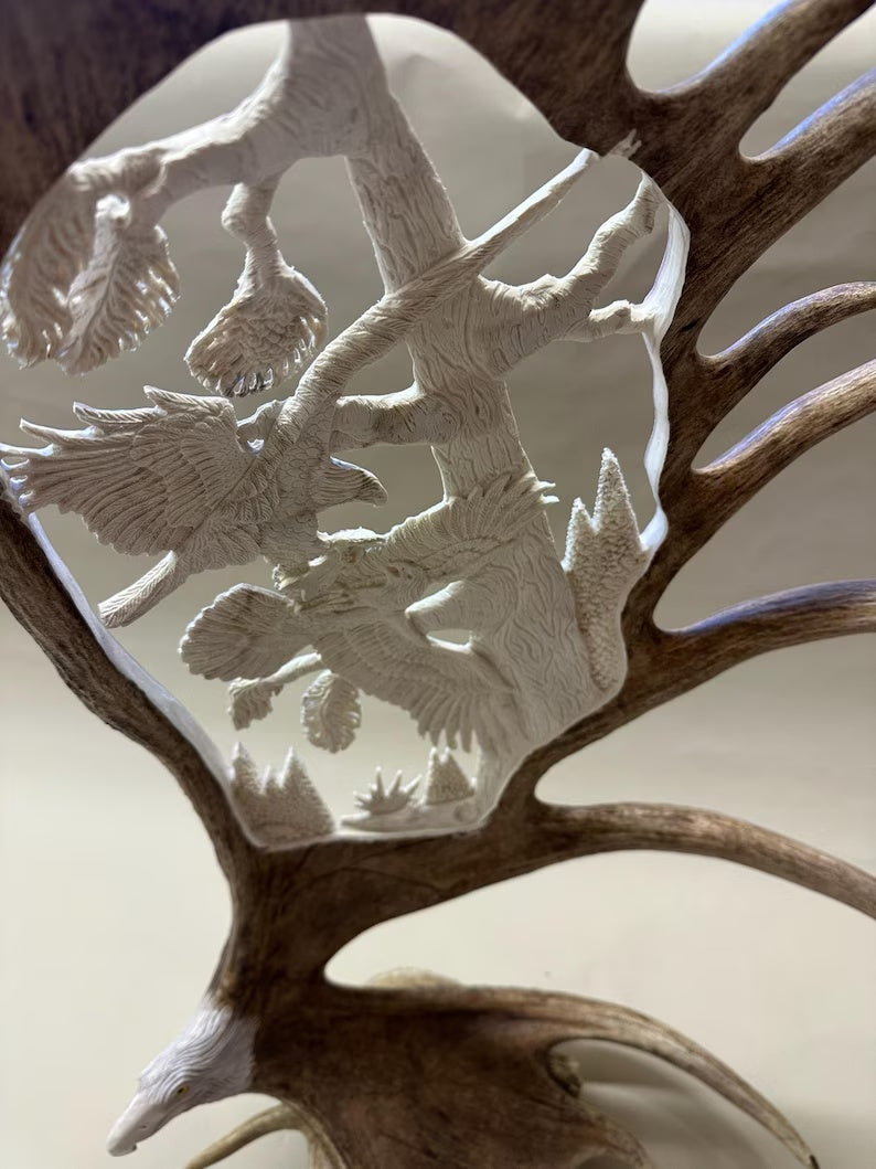 Close detail of Fighting Eagles over Fish hand-carved moose antler sculpture